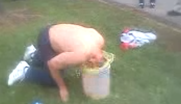 Guy sticks head in bucket of pee Guy sticks head in bucket of pee
